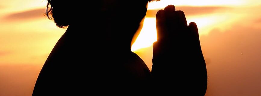 silhouette image of person praying