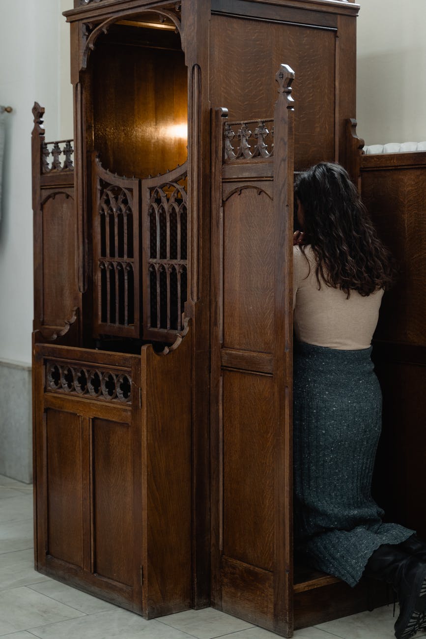 woman kneeling and making a confession